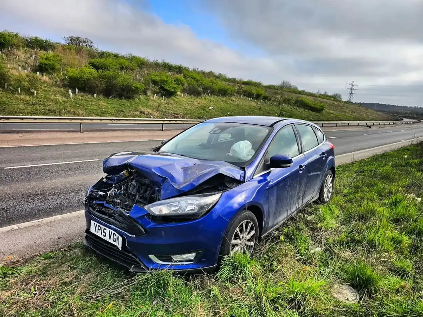 Accident recovery - damaged car being loaded onto flatbed after collision